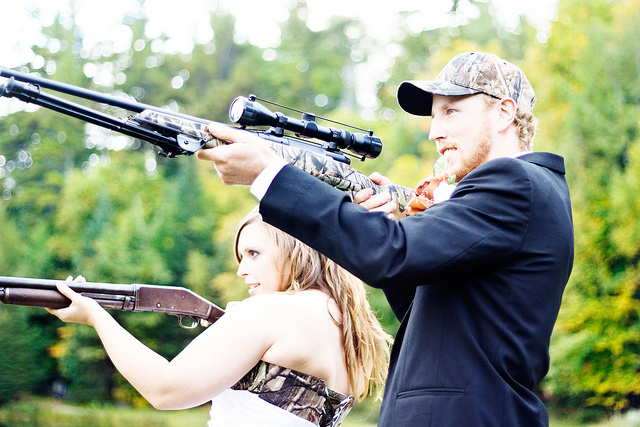 A shot of Julie and Mel with guns after the wedding.