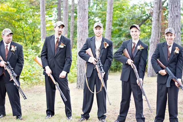 A shot of the groomsmen posing with their guns.